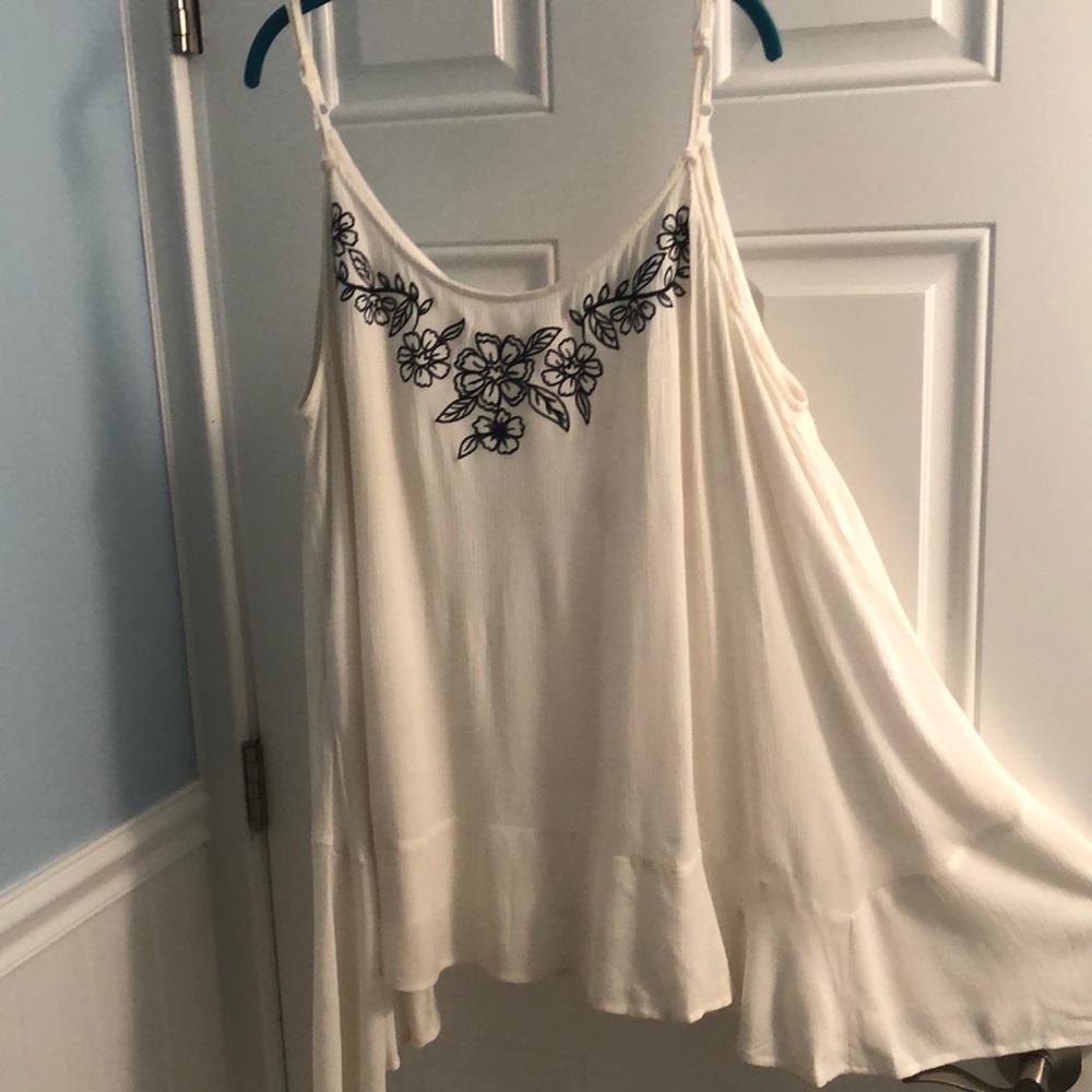 Beach dress with dark blue embroidery.